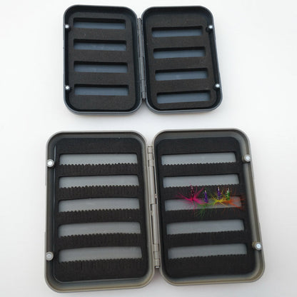 Open small and large fly boxes showing different foam layouts