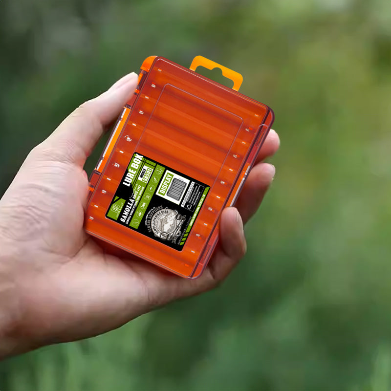Hand holding a compact orange lure box